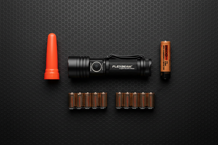 Powertac Storm Outage Kit flat lay — FlexBeam flashlight, orange cone beacon adapter, 18650 rechargeable battery, and 2x CR123A 10-packs on dark tactical surface